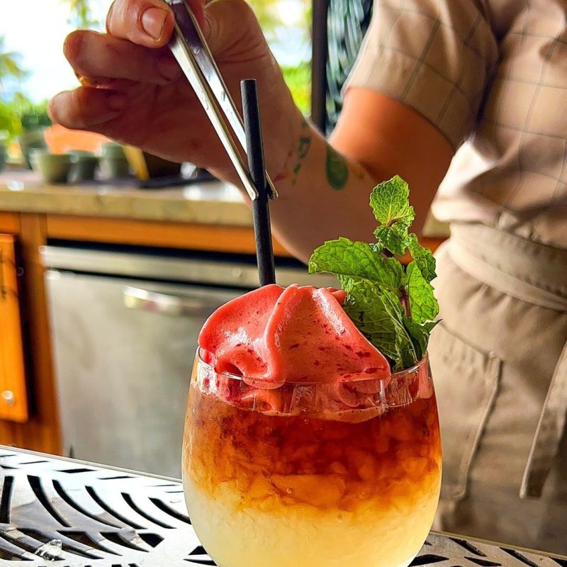 a person sitting at a table with a plate of food
