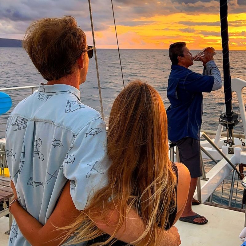 a man and a woman standing next to a body of water