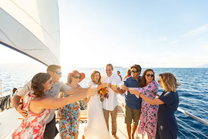 a group of people standing next to a body of water