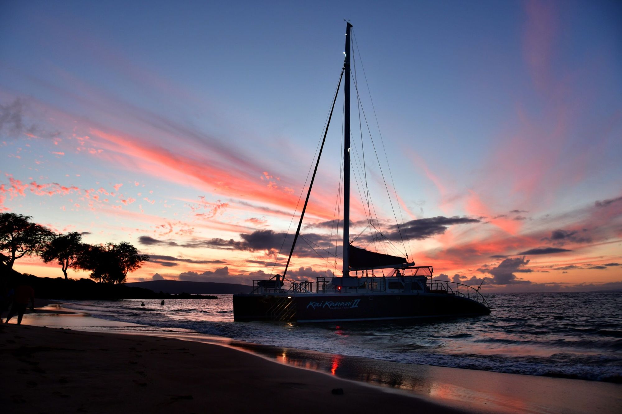 Kai Kanani catamaran sailing at sunset in South Maui