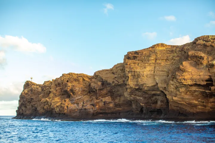 a large body of water with a mountain in the background