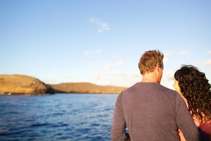 a man standing in front of a body of water