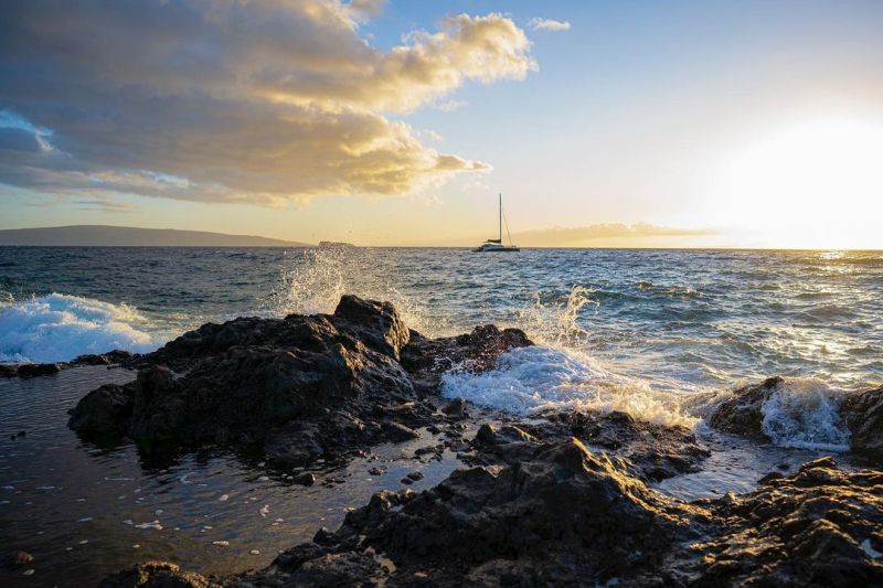 a body of water with a mountain in the ocean